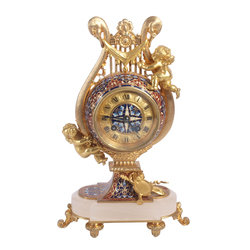 A gilded bronze mantel clock with multi-color enamel on the mountain crystal base