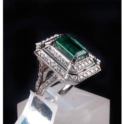 White gold ring with diamonds and emerald