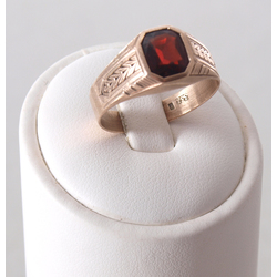 Gold ring with a red stone