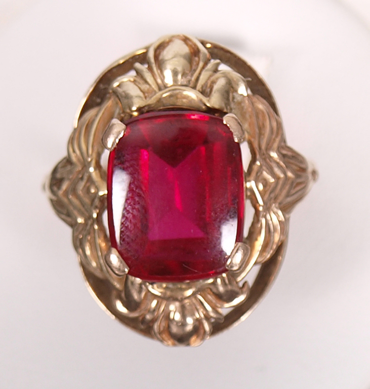 Gold ring with a red stone