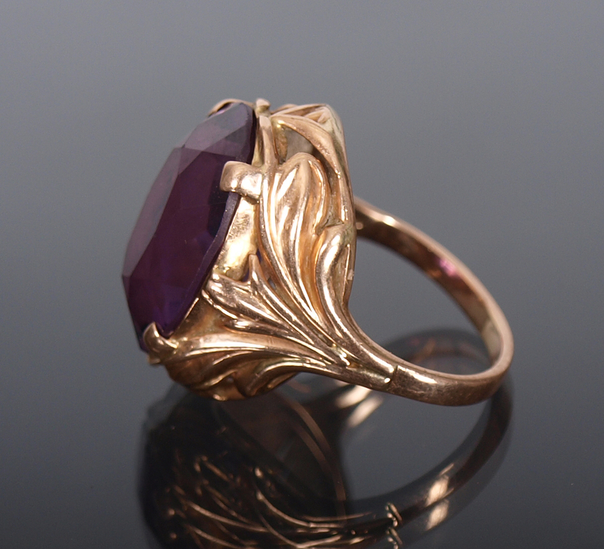 Gold ring with a purple stone