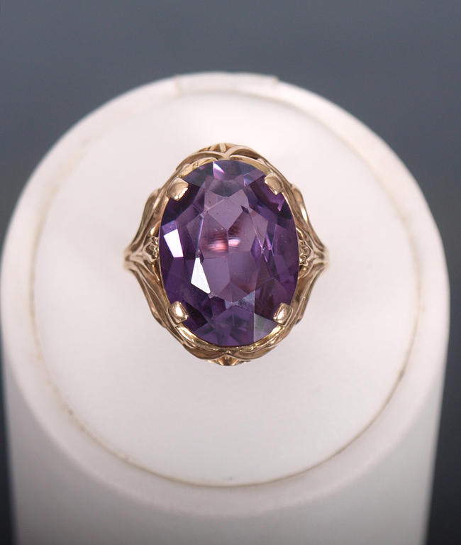 Gold ring with a purple stone