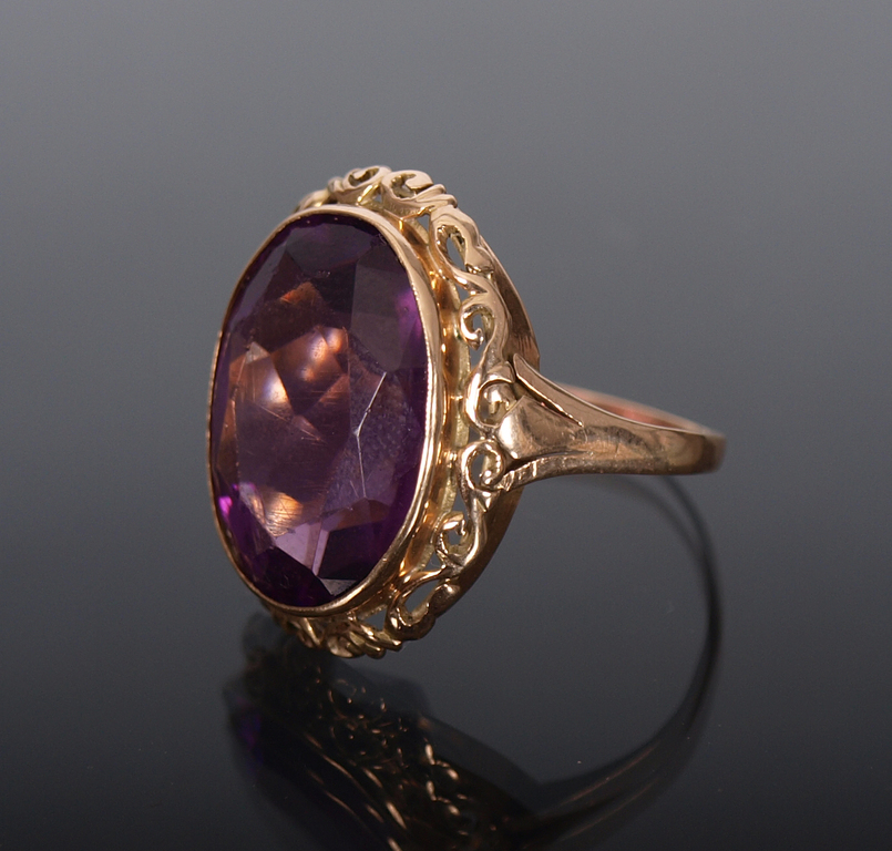 Gold ring with a purple stone