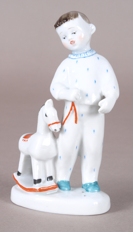 Porcelain figure „Child with rocking horse”