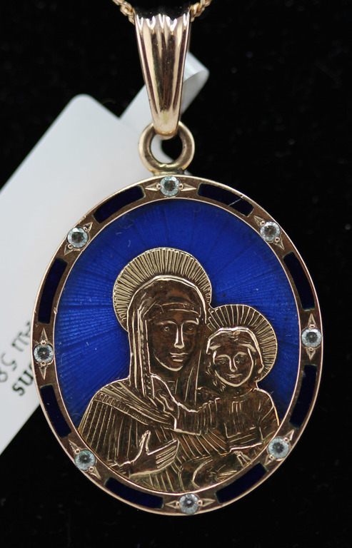 Gold pendant with a religious theme