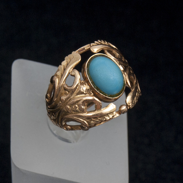 Golden ring with a blue stone
