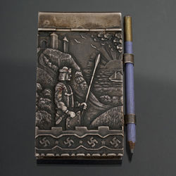 Silver notebook with pencil