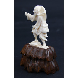 Bone figurine on the wooden base 