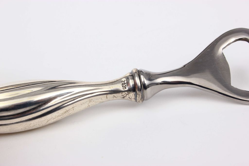 Silver bottle opener in Baroque style