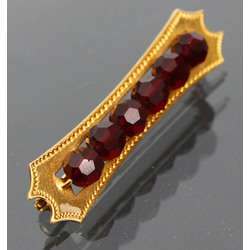 Golden brooch with garnets