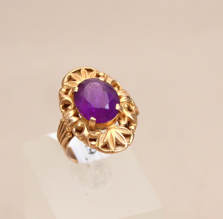 Golden ring with a purple stone