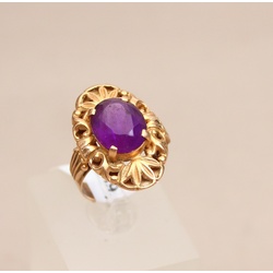 Golden ring with a purple stone