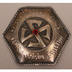 Silver brooch with red stone 