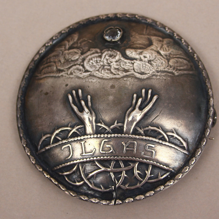 Silver brooch with white stone 