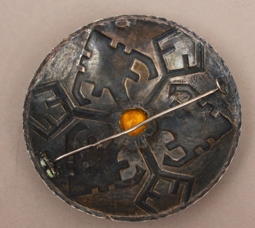 Silver brooch with yellow stone