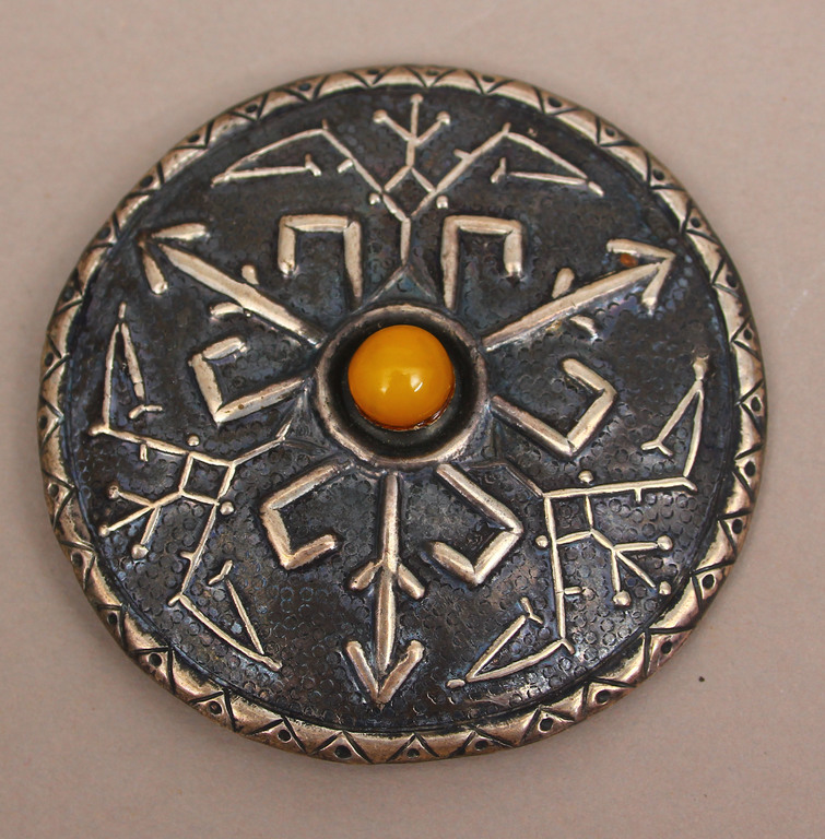 Silver brooch with embedded amber
