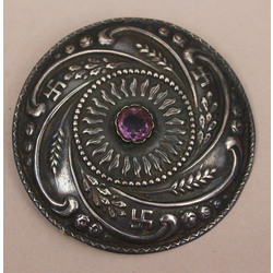 Silver brooch with purple stone