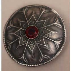 Silver brooch with red stone