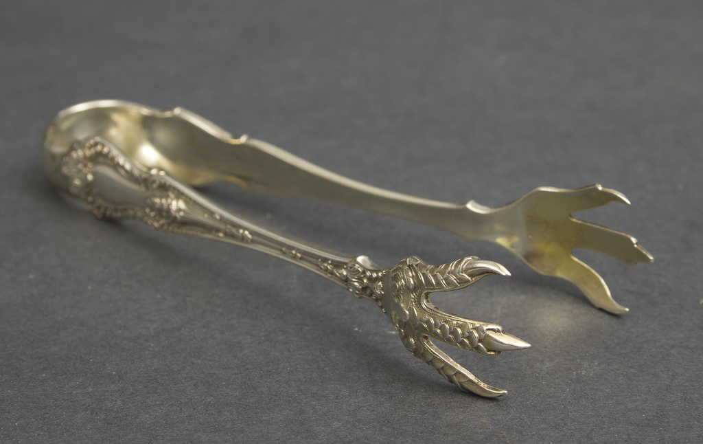 Silver sugar tongs with eagle paws