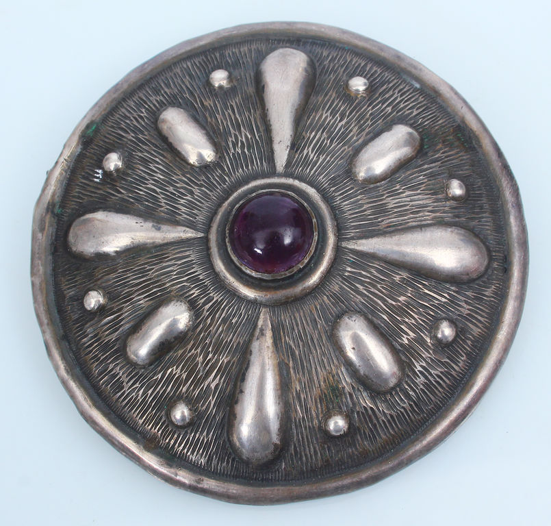 Silver brooch with purple stone