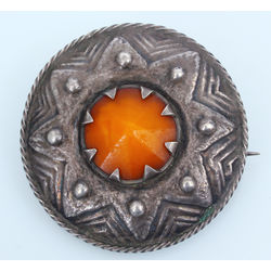 Silver brooch with amber