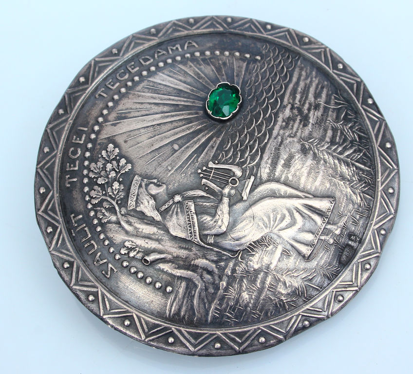 Silver brooch with green stone 