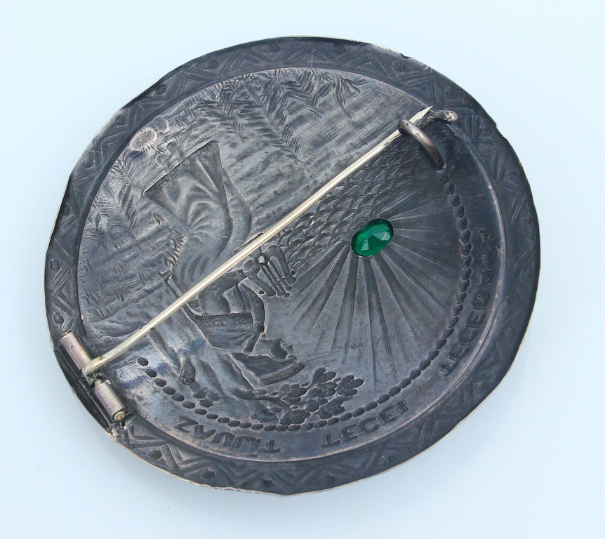 Silver brooch with green stone 