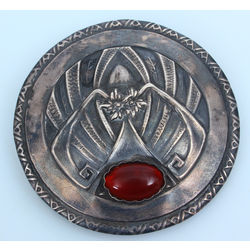 Silver brooch with red stone