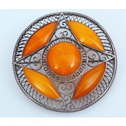 Silver brooch with amber