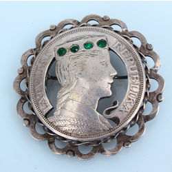Silver brooch from the five-lat coin with green stones