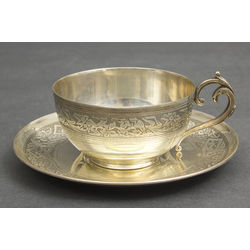 Silver cup with saucer