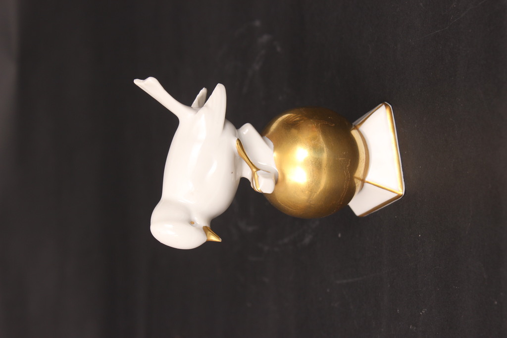Porcelain bird on a gilded ball