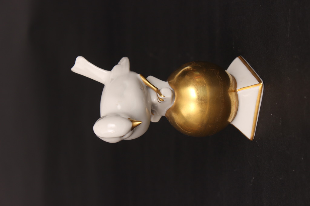 Porcelain bird on a gilded ball