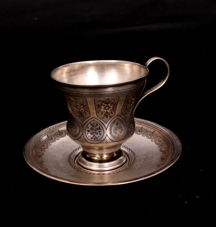 Silver cup with saucer