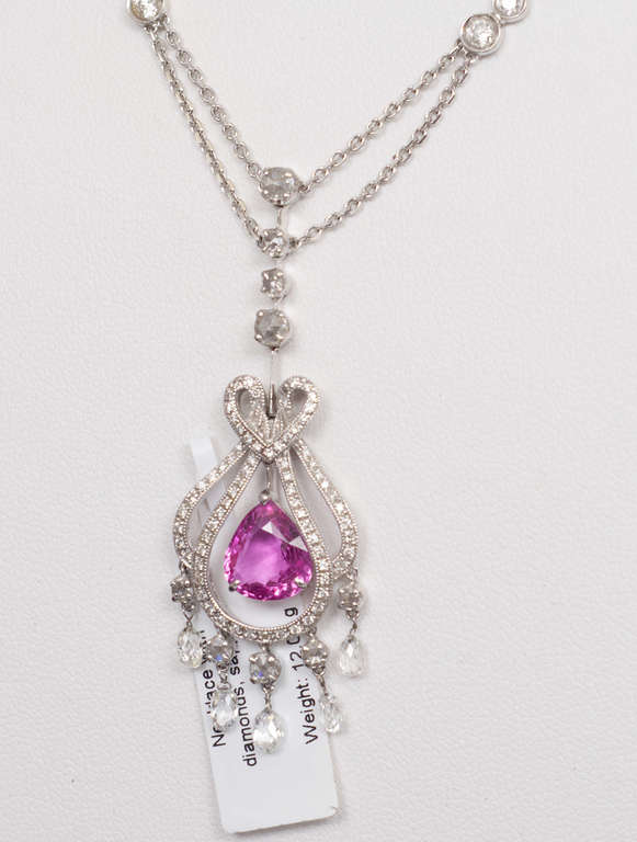 Gold pendant with 103 natural diamonds and sapphires