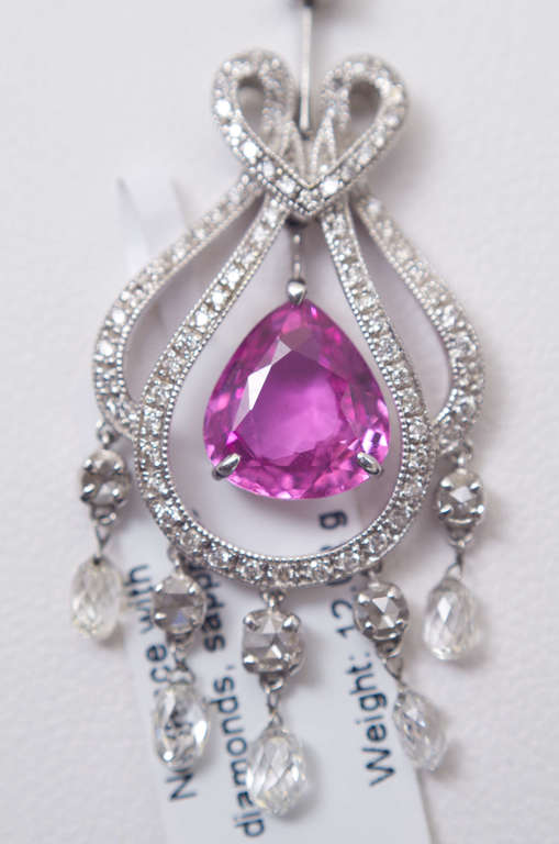 Gold pendant with 103 natural diamonds and sapphires