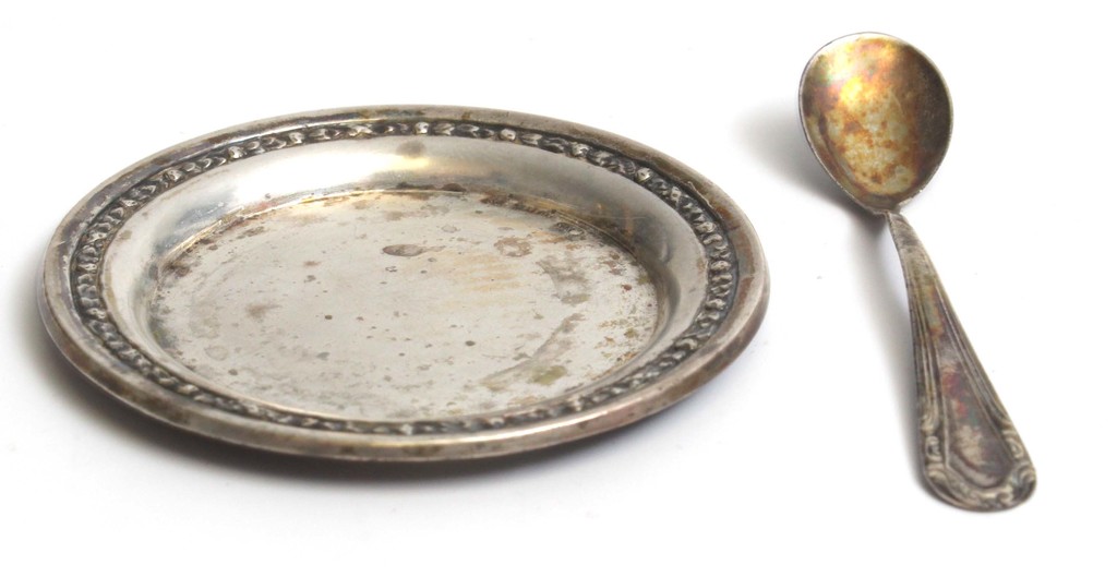 A small silver plate with a spoon