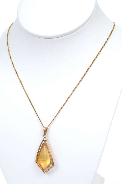 Gold pendant with yellow stone and chain