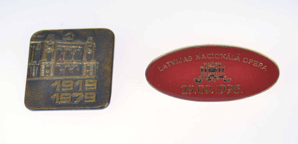 Two metal badges 