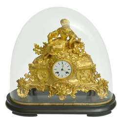 Fireplace clock on a wooden base with a glass dome
