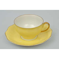 Yellow porcelain cup with saucer