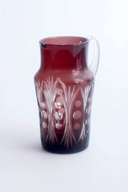 Glass jug with polished ornament