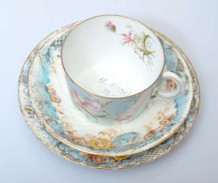 Porcelain cup with two saucers