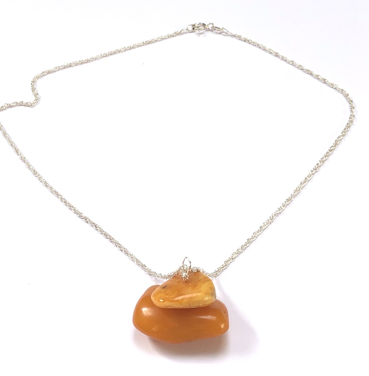 Vintage Yellow amber pendant on a silver chain.
