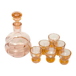 A rum decanter with a label and six glasses
