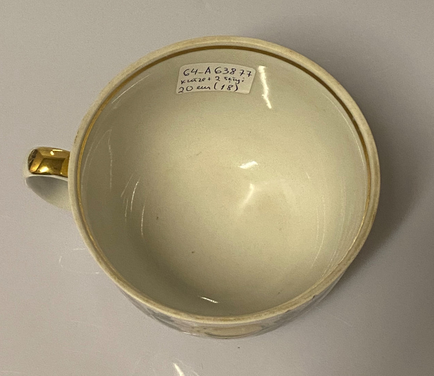 Porcelain tea cup with 2 saucers