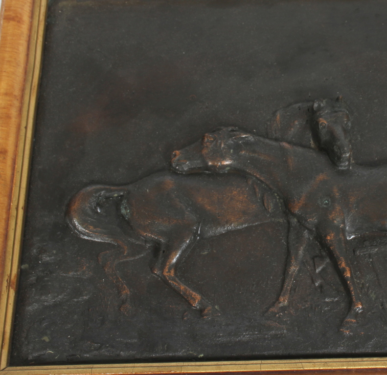 Bronze casting in wooden frame 