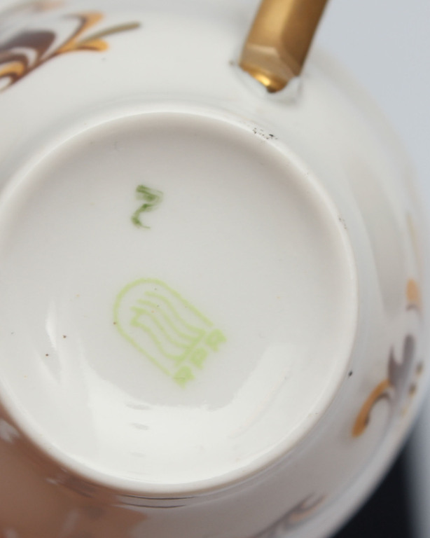 Four coffee cups with a dessert plate