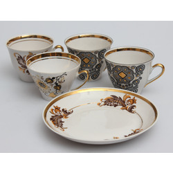 Four coffee cups with a dessert plate
