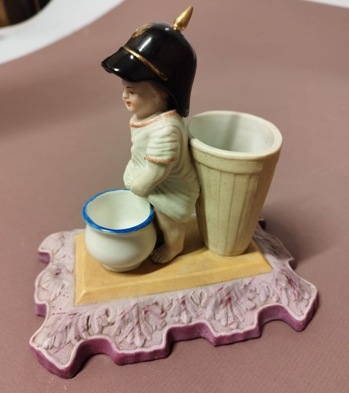 Biscuit figurine with a sculpture of a peeing boy